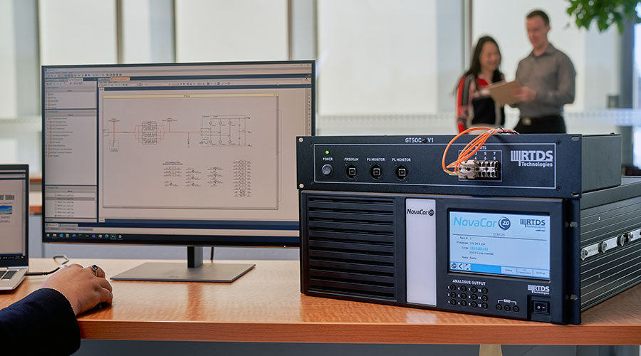 A user works with the RTDS Simulator at a desk